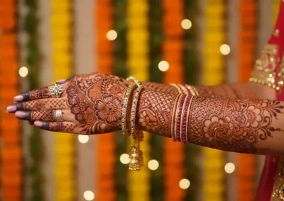 A skilled artist from Anmol Mehandi Art applying intricate bridal henna on a client's hands, showcasing why they are the best mehndi artist in Noida Sector 137.